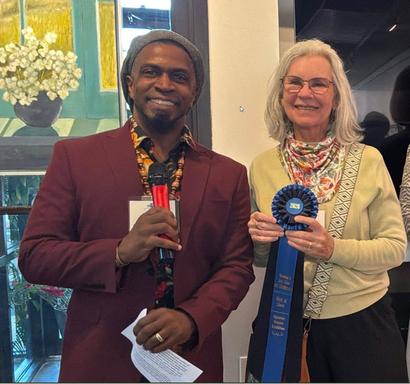 Cedric Fox giving First Place ribbon to Nancy Achberger